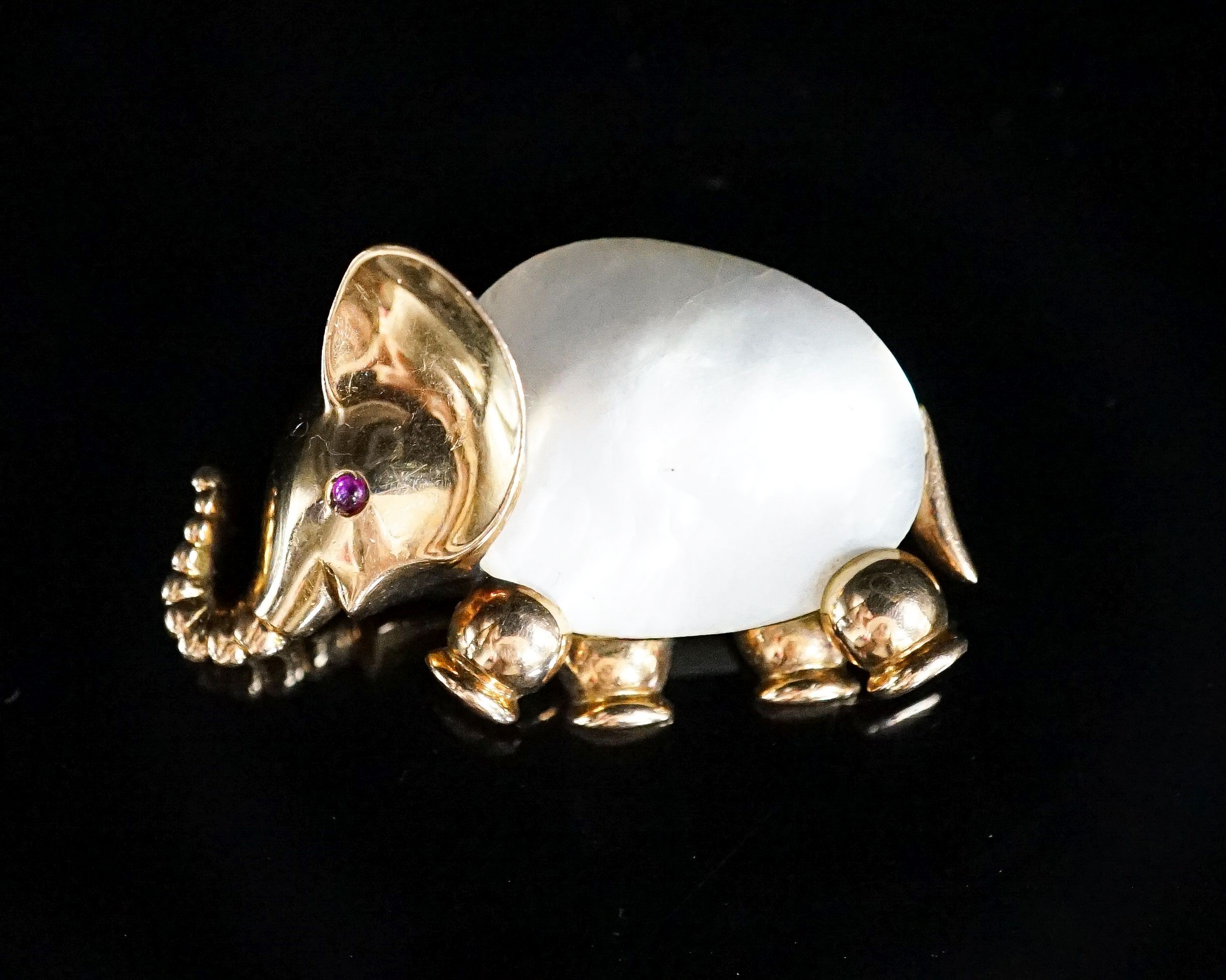 A 20th century Viennese 585 yellow metal, mother of pearl and ruby chip set brooch, modelled as an elephant, 35mm, gross weight 12.7 grams.